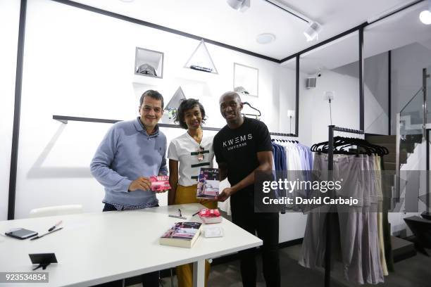 Stephane Mbia signs autographs at the Kwems clothing store with writer Roberto Arrocha on February 23, 2018 in Seville, Spain.