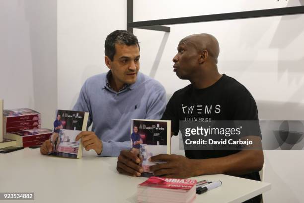 Stephane Mbia signs autographs at the Kwems clothing store with writer Roberto Arrocha on February 23, 2018 in Seville, Spain.