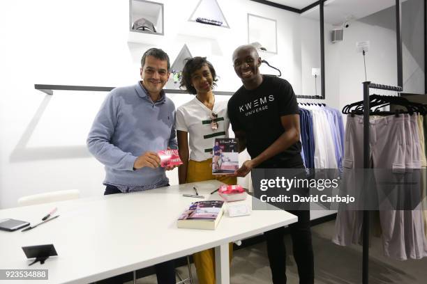 Stephane Mbia signs autographs at the Kwems clothing store with writer Roberto Arrocha on February 23, 2018 in Seville, Spain.