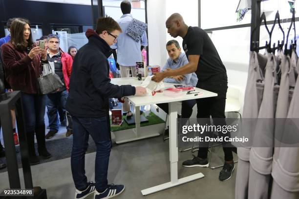 Stephane Mbia signs autographs at the Kwems clothing store with writer Roberto Arrocha on February 23, 2018 in Seville, Spain.