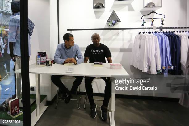 Stephane Mbia signs autographs at the Kwems clothing store with writer Roberto Arrocha on February 23, 2018 in Seville, Spain.