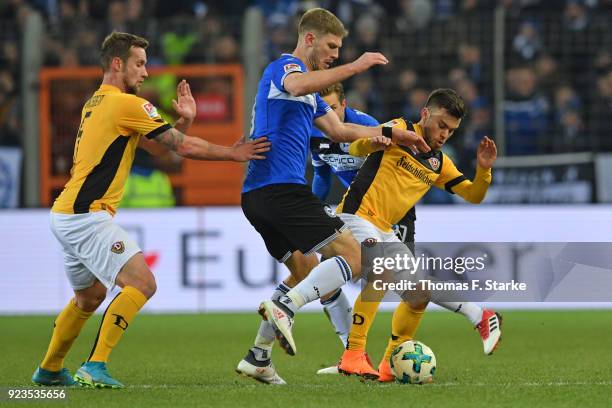 Manuel Konrad and Sascha Horvath of Dresden tackle Fabian Klos of Bielefeld during the Second Bundesliga match between DSC Arminia Bielefeld and SG...