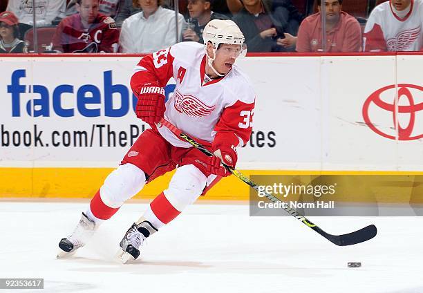 Kris Draper of the Detroit Red Wings skates the puck up ice against the Phoenix Coyotes on October 22, 2009 at Jobing.com Arena in Glendale, Arizona.