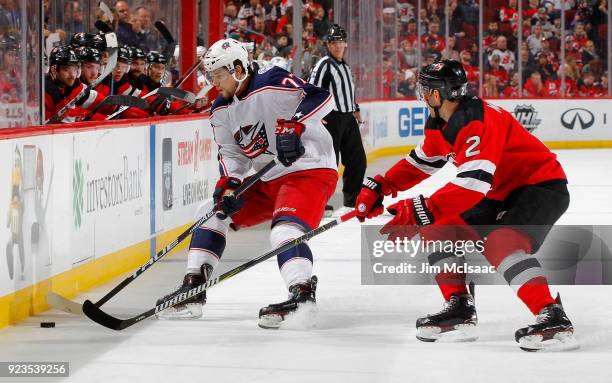 Josh Anderson of the Columbus Blue Jackets in action against John Moore of the New Jersey Devils on February 20, 2018 at Prudential Center in Newark,...
