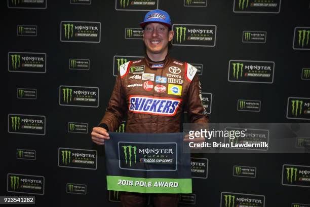 Kyle Busch, driver of the Snickers Almond Toyota, poses with the Pole Award after qualifying for the pole position for the Monster Energy NASCAR Cup...