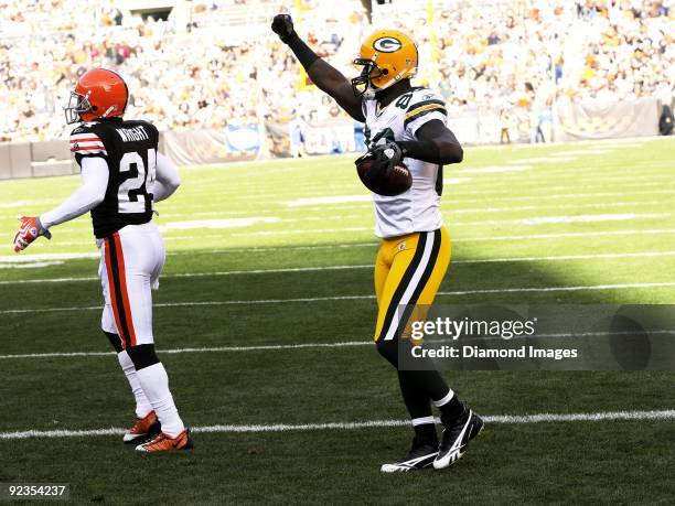 Wide receiver James Jones of the Green Bay Packers celebrates his five-yard touchdown reception as defensive back Eric Wright of the Cleveland Browns...