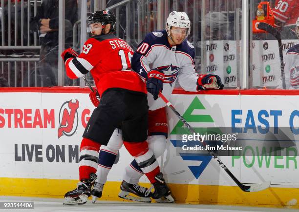 Alexander Wennberg of the Columbus Blue Jackets in action against Drew Stafford of the New Jersey Devils on February 20, 2018 at Prudential Center in...