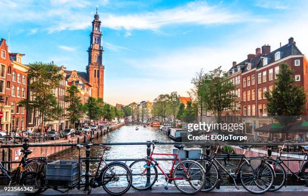 view of canal in amsterdam - amsterdam foto e immagini stock