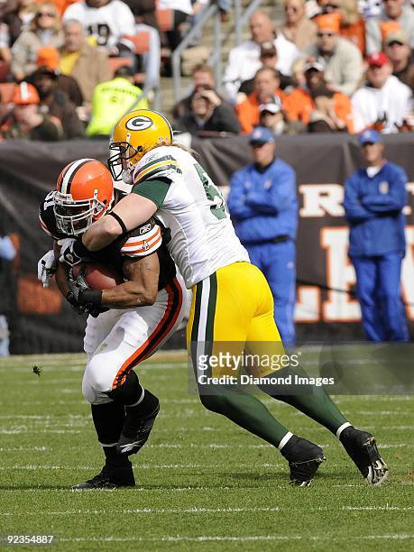 Linebacker A. J. Hawk of the Green Bay Packers tackles running back Jamal Lewis of the Cleveland Browns during a game on October 25, 2009 at...