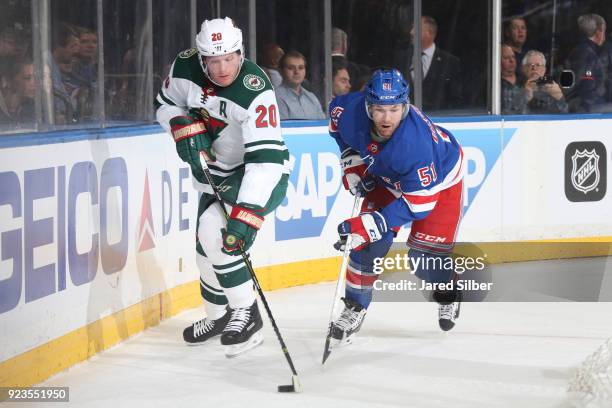 Ryan Suter of the Minnesota Wild skates with the puck against David Desharnais of the New York Rangers at Madison Square Garden on February 23, 2018...