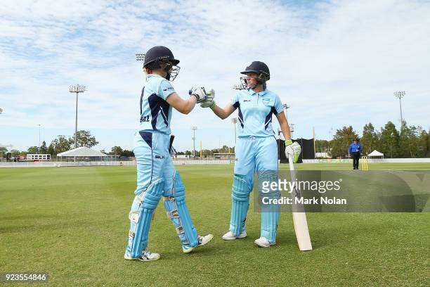 Alex Blackwell of NSW is greeted by Alyssa Healy as she comes out to batduring the WNCL Final match between New South Wales and Western Australia at...