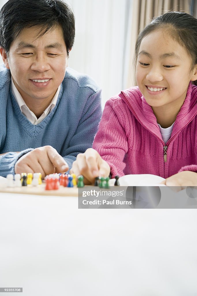 Asian Father and Daughter playing