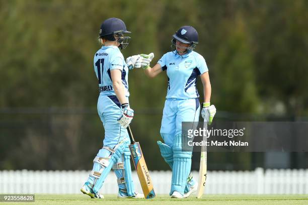 Alex Blackwell and Alyssa Healy of NSW meet mid wicket during the WNCL Final match between New South Wales and Western Australia at Blacktown...