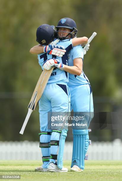 Allyssa Healy of NSW celebrates scoring a century with team mate Ellyse Perry during the WNCL Final match between New South Wales and Western...