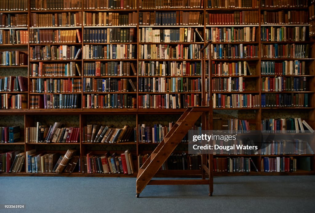 Traditional wooden steps in vintage library.