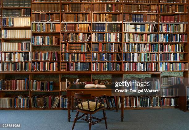 open book on writing desk in traditional library. - bookshelf stock pictures, royalty-free photos & images