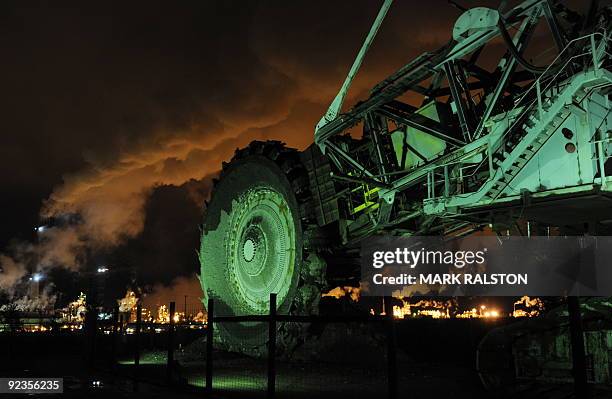 Disused mining machine is displayed in front of the Syncrude oil sands extraction facility near the town of Fort McMurray in Alberta Province, Canada...