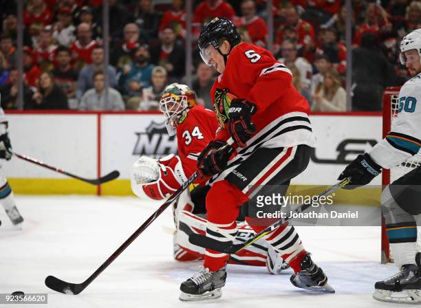 Connor Murphy of the Chicago Blackhawks clears the puck against the San Jose Sharks at the United Center on February 23, 2018 in Chicago, Illinois.