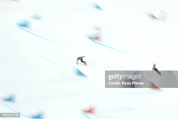 Sangho Lee of Korea and Dmitry Loginov of Olympic Athlete from Russia compete during the Men's Parallel Giant Slalom Run on day fifteen of the...