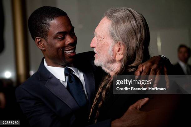 Comedian Chris Rock hugs singer Willie Nelson at the 12th annual Mark Twain Prize for American Humor at the John F. Kennedy Center on October 26,...