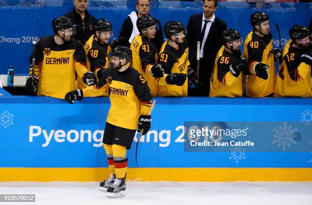 Felix Schutz of Germany celebrates with teammates during Men's Semifinal ice hockey match between Canada and Germany on day fourteen of the 2018...
