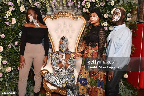 Artist Laolu Senbanjo poses with models painted with his work as Instagram celebrates #BlackGirlMagic and #BlackCreatives on February 23, 2018 in New...