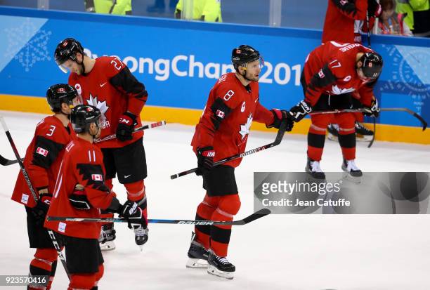 Cody Goloubef, Wojtek Wolski and teammates of Canada look dejected after defeat in Men's Semifinal ice hockey match between Canada and Germany on day...