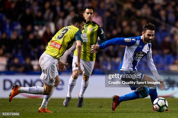 Adrian Lopez of Deportivo de La Coruna is challenged by Aaron Martin of RCD Espanyol during the La Liga match between Deportivo La Coruna and...