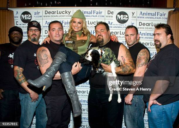 Fox 5 reporter Courtney Friel is held aloft by cast members of Rescue Ink at the 9th Annual Animal Fair Magazine's Halloween Pet Costume Party at 530...