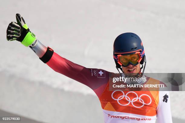 Switzerland's Ramon Zenhaeusern celebrates after winning the Alpine Skiing Team Event big final at the Jeongseon Alpine Center during the Pyeongchang...