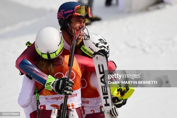 Switzerland's Ramon Zenhaeusern celebrates with Switzerland's Wendy Holdener and Switzerland's Denise Feierabend after they won the Alpine Skiing...
