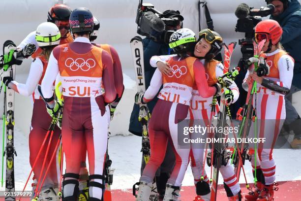 Austria's team congratulate Switzerland's team after the Alpine Skiing Team Event big final at the Jeongseon Alpine Center during the Pyeongchang...