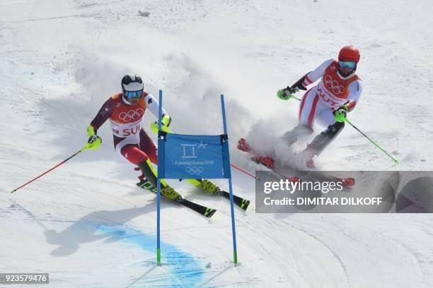 Switzerland's Daniel Yule and Austria's Marco Schwarz compete in the Alpine Skiing Team Event big final at the Jeongseon Alpine Center during the...