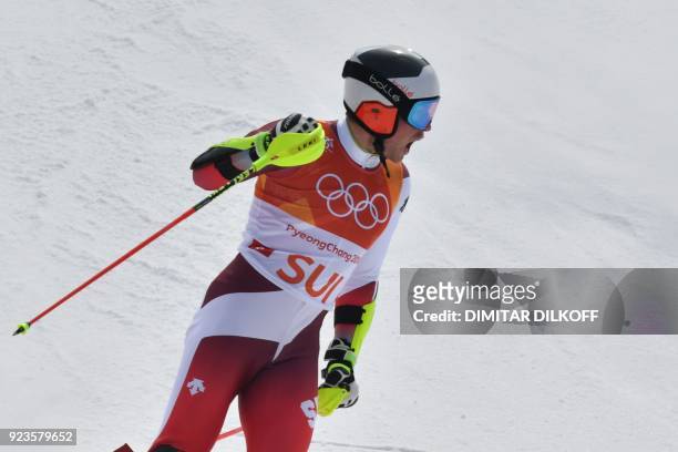 Switzerland's Daniel Yule reacts as he crosses the finish-line in the Alpine Skiing Team Event big final at the Jeongseon Alpine Center during the...