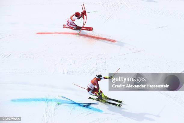 Daniel Yule of Switzerland and Marco Schwarz of Austria compete during the Alpine Team Event Big Final on day 15 of the PyeongChang 2018 Winter...