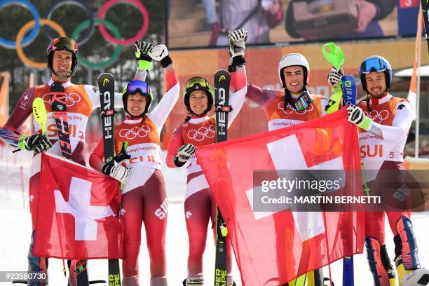 Switzerland's winners Ramon Zenhaeusern, Denise Feierabend, Wendy Holdener, Daniel Yule and Luca Aerni celebrate on the podium during the victory...