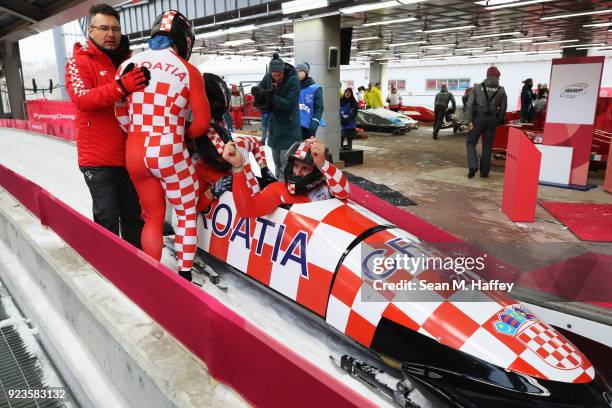 Drazen Silic, Benedikt Nikpalj, Mate Mezulic and Antonio Zelic of Croatia react in the finish area during 4-man Bobsleigh Heats on day fifteen of the...