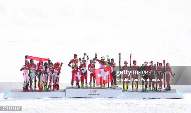 Gold medallists Switzerland with Ramon Zenhaeusern, Daniel Yule, Luca Aerni, Wendy Holdener and Denise Feierabend celebrate with silver medallists...