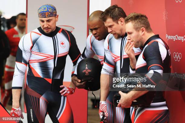 Justin Kripps, Jesse Lumsden, Alexander Kopacz and Oluseyi Smith of Canada react in the finish area during 4-man Bobsleigh Heats on day fifteen of...