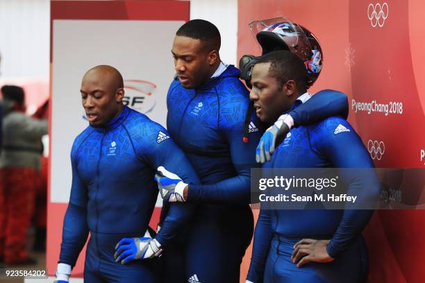 Lamin Deen, Ben Simons, Toby Olubi and Andrew Matthews of Great Britain react in the finish area during 4-man Bobsleigh Heats on day fifteen of the...