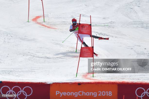 Austria's Marco Schwarz fails to clear a gate as he competes in the Alpine Skiing Team Event big final at the Jeongseon Alpine Center during the...