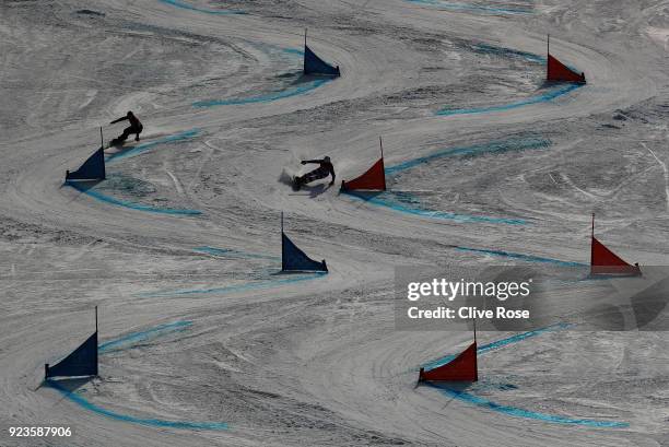 Vic Wild of Olympic Athlete from Russia and Roland Fischnaller of Italy compete during the Men's Snowboard Parallel Giant Slalom 1/8 Final on day...