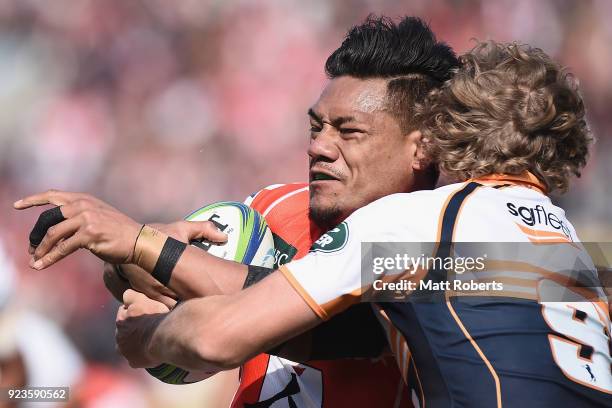 Lomano Lava Lemeki of the Sunwolves is tackled by Joe Powell of the Brumbies during the Super Rugby round 2 match between Sunwolves and Brumbies at...