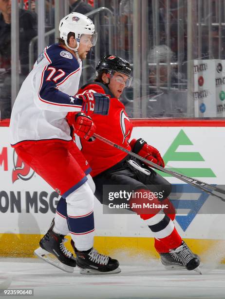 Josh Anderson of the Columbus Blue Jackets in action against Nico Hischier of the New Jersey Devils on February 20, 2018 at Prudential Center in...