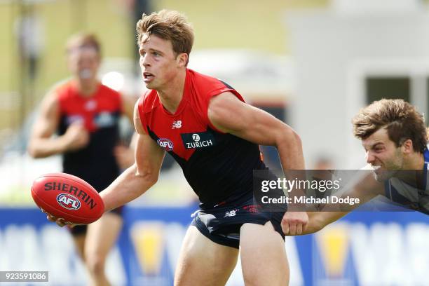 Mitch Hannan of the Demons looks upfield Luke McDonald during the JLT Community Series AFL match between the North Melbourne Kangaroos and the...