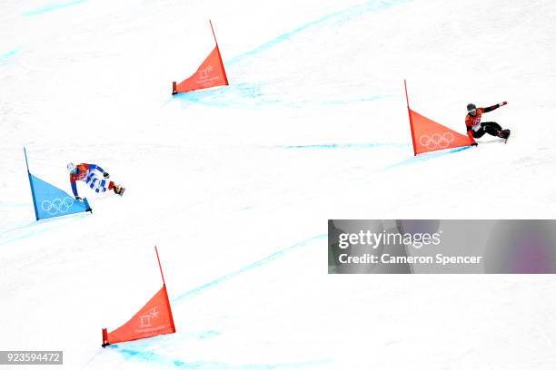 Roland Fischnaller of Italy and Nevin Galmarini of Switzerland compete during the Men's Snowboard Parallel Giant Slalom Quarterfinal on day fifteen...