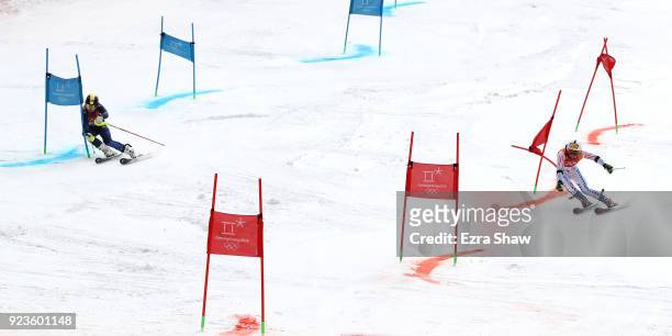 Charlie Guest of Great Britain and Megan McJames of the United States compete during the Alpine Team Event 1/8 Finals on day 15 of the PyeongChang...