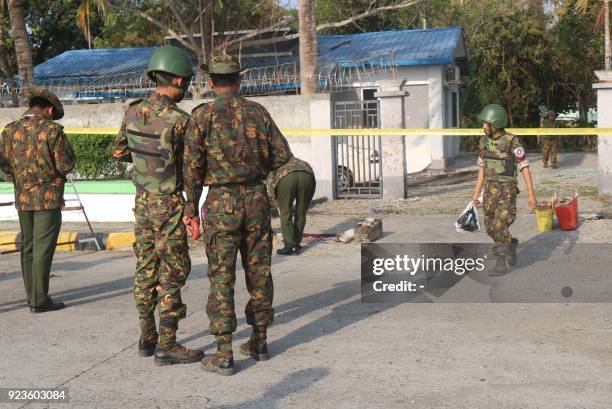 Members of the military and police stand near the site of an early morning explosion in the compound of the state government secretary's home in...