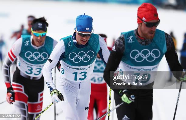 Max Hauke of Austria, Matti Heikkinen of Finland and Thomas Bing of Germany compete during the Men's 50km Mass Start Classic on day 15 of the...