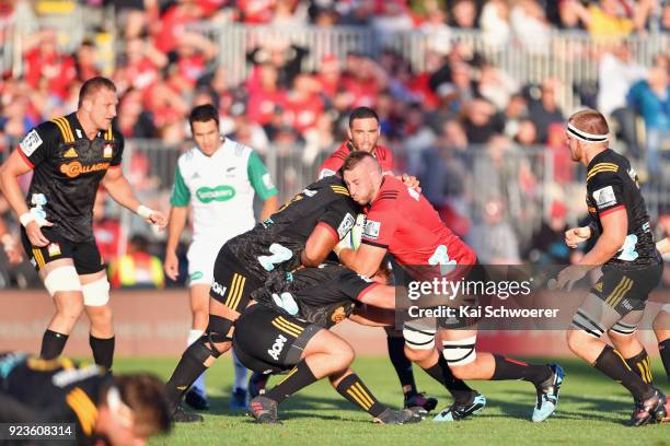 Luke Romano of the Crusaders is tackled during the round two Super Rugby match between the Crusaders and the Chiefs at AMI Stadium on February 24,...